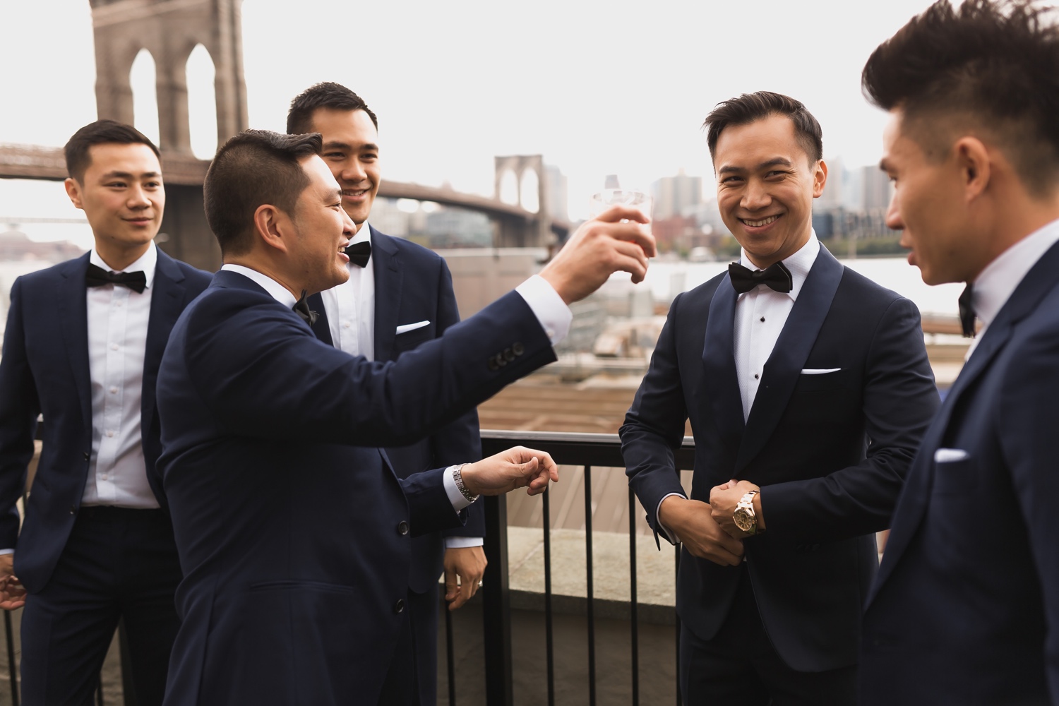 A groom and his groomsmen getting ready in a Mr. C Seaport Hotel for his wedding at Cipriani Wall Street in New York City.