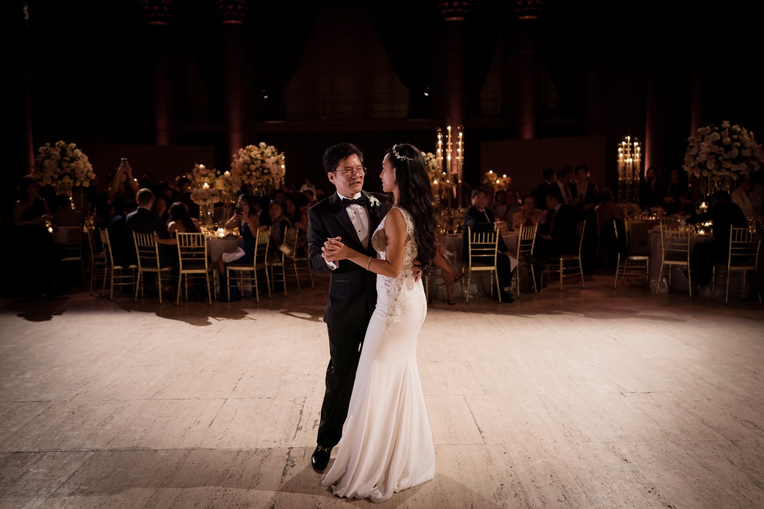 A newly wedded wife dancing with her father during a wedding reception at Cipriani Wall Street in New York City.