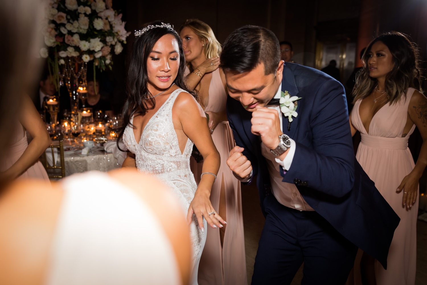 A bride dancing with a groomsman during