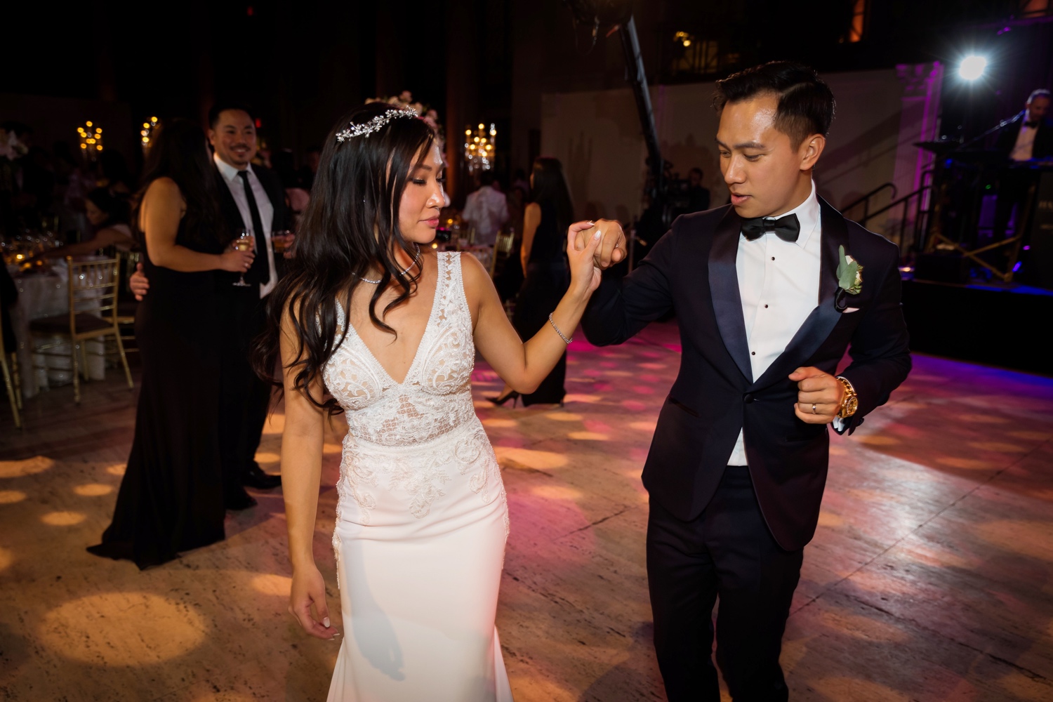 A newly wedded couple dancing together during a wedding reception 