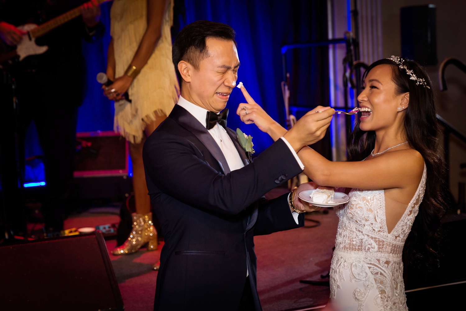 A newly wedded wife teasing his husband with her wedding cake during a wedding reception at Cipriani Wall Street in New York City.