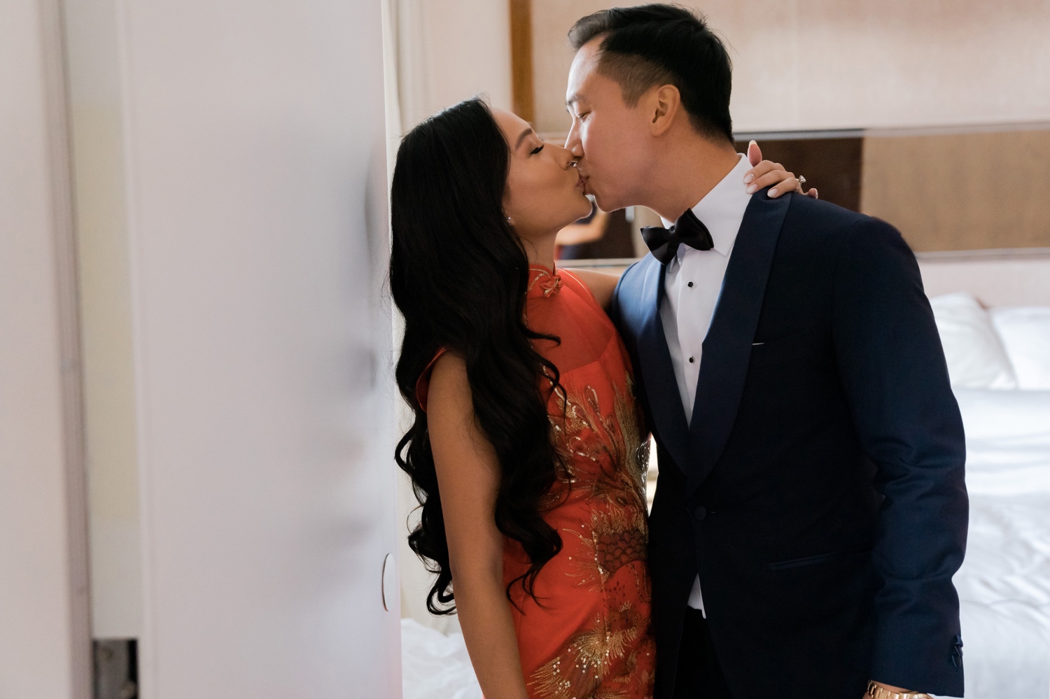 A bride and a groom kissing in Mr. C Seaport Hotel on a wedding day at Cipriani Wall Street in New York City. 