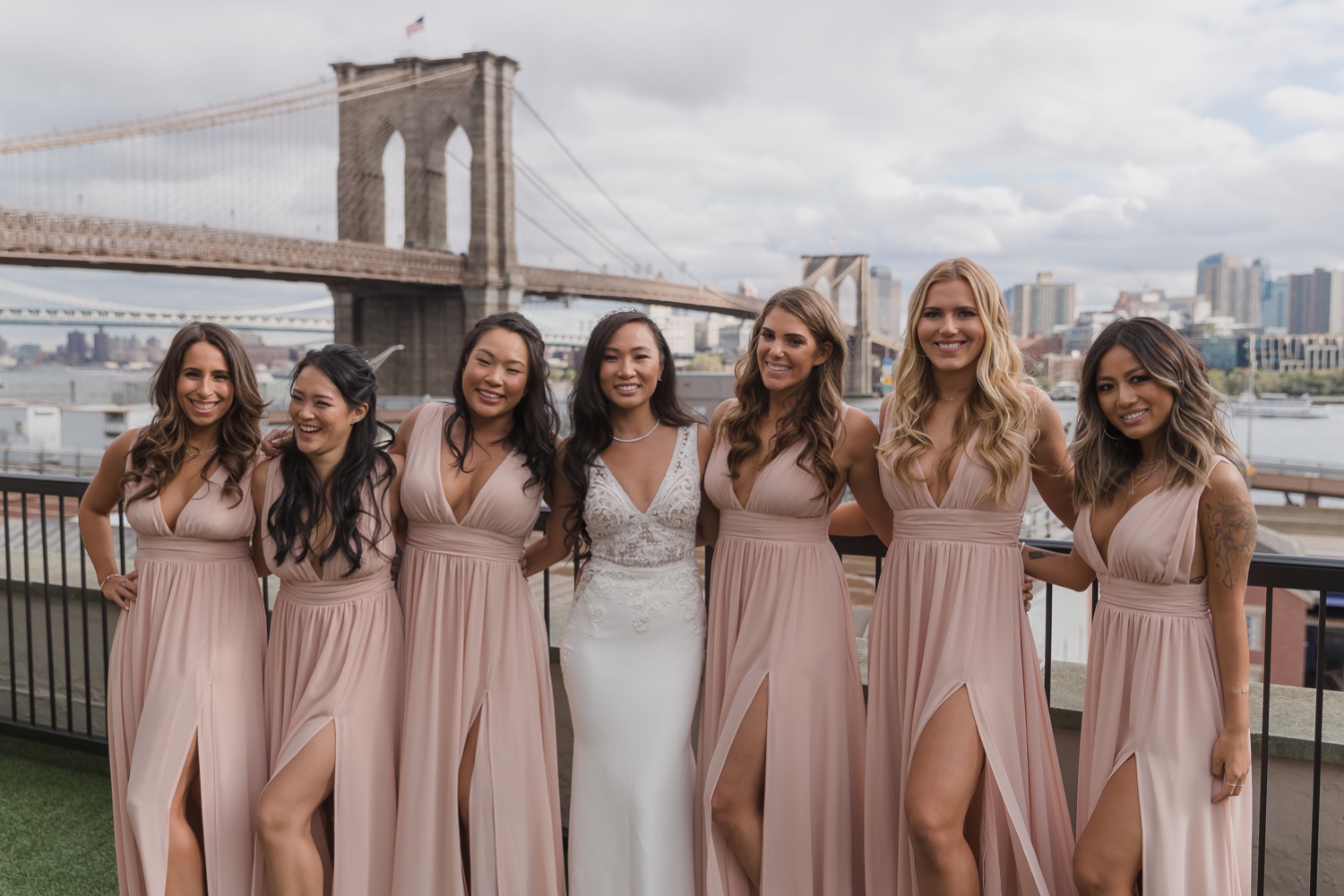 A portrait session of a bride with her wedding dress and her bridesmaids in Mr. C Seaport Hotel on a wedding day at Cipriani Wall Street in New York City. Wedding Dress by Pronovias