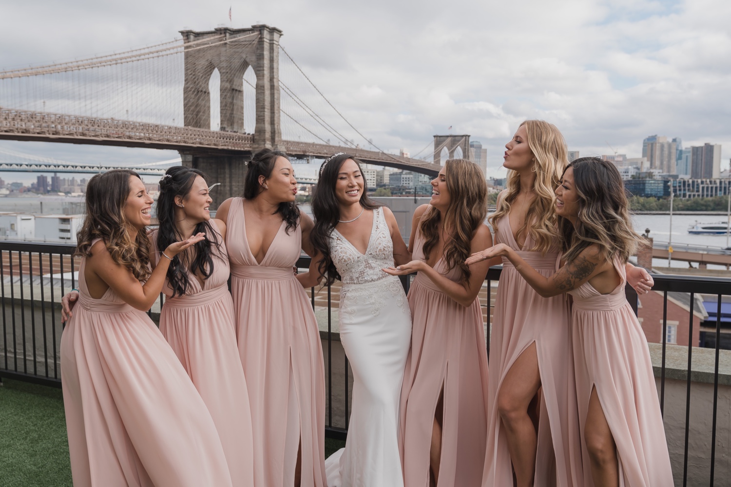 A portrait session of a bride with her wedding dress and her bridesmaids in Mr. C Seaport Hotel on a wedding day at Cipriani Wall Street in New York City. Wedding Dress by Pronovias