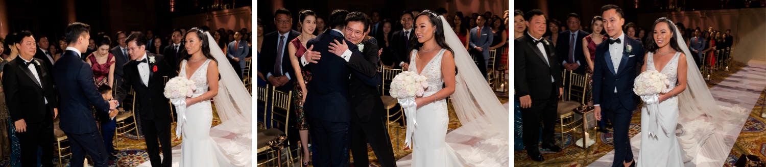 A bride's father hugging a groom and wishing the couple well during a wedding ceremony at Cipriani Wall Street in New York City. 