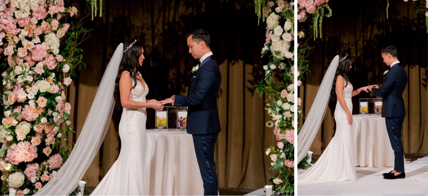 A bride and a groom exchanging their wedding rings during a wedding ceremony at Cipriani Wall Street in New York City. Wedding Dress by Pronovias