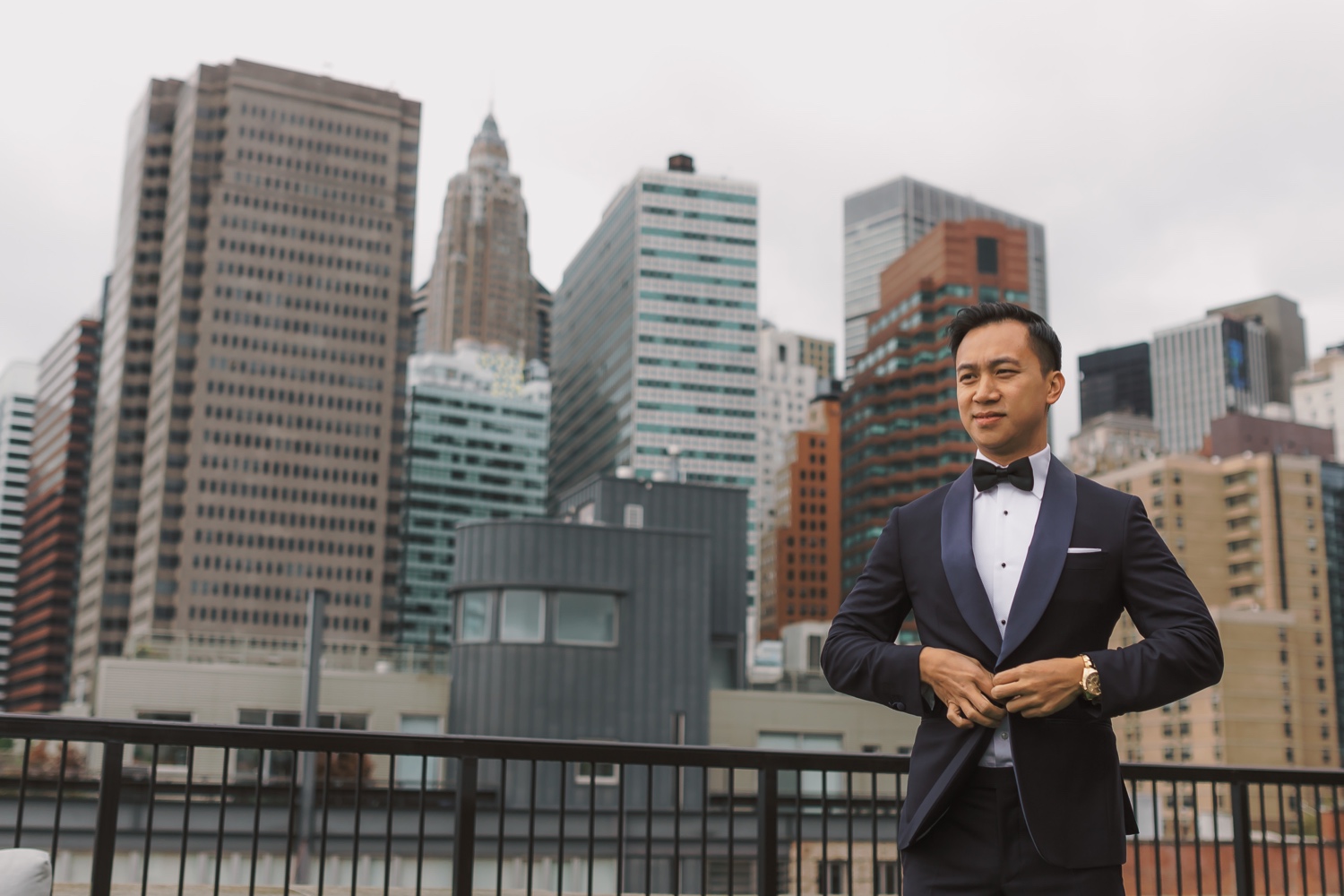 A groom wearing his wedding suit in a Mr. C Seaport Hotel on a wedding day at Cipriani Wall Street in New York City.