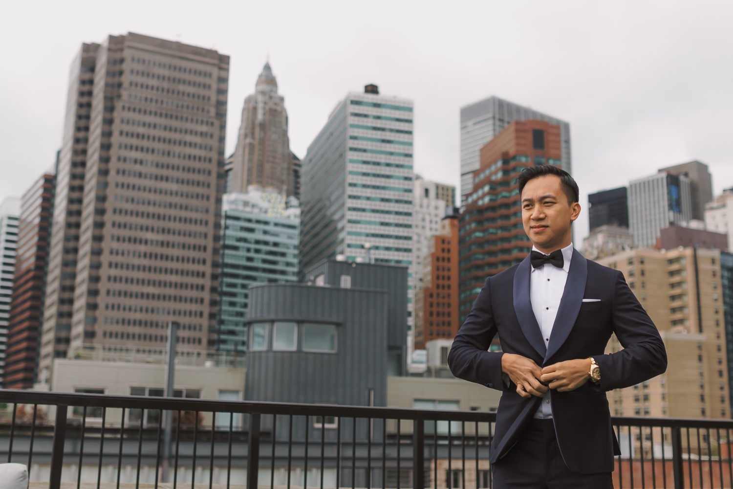 A groom wearing his wedding suit in a Mr. C Seaport Hotel on a wedding day at Cipriani Wall Street in New York City. 