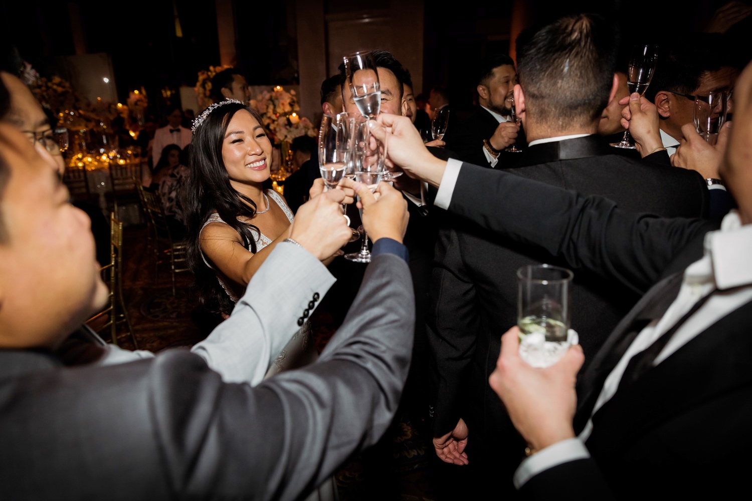 Wedding guests celebrating a bride's marriage during a wedding reception at Cipriani Wall Street in New York City.