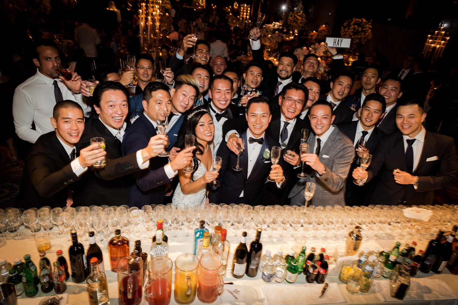 Wedding guests and a newly wedded couple posing for a group picture during a wedding reception at Cipriani Wall Street in New York City. 