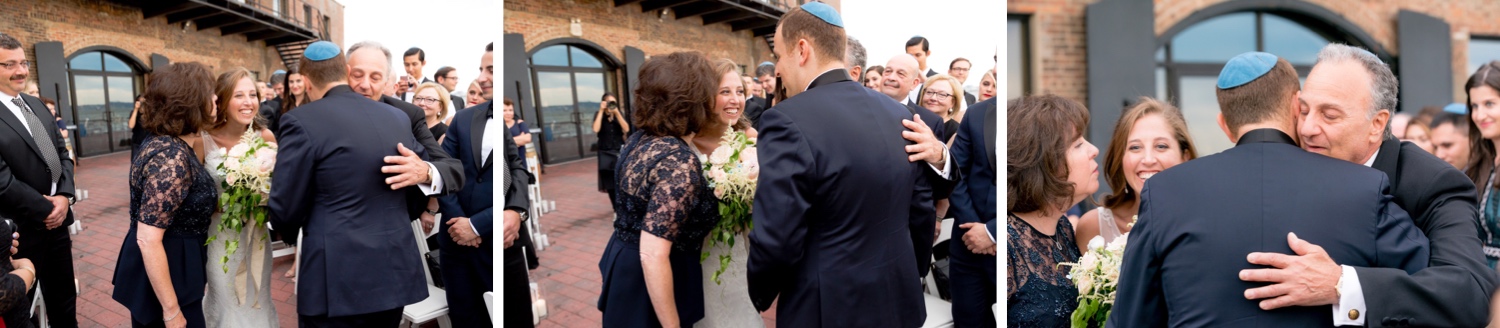 A groom greeting a bride and her parents during a wedding ceremony at Liberty Warehouse, Brooklyn New York. 