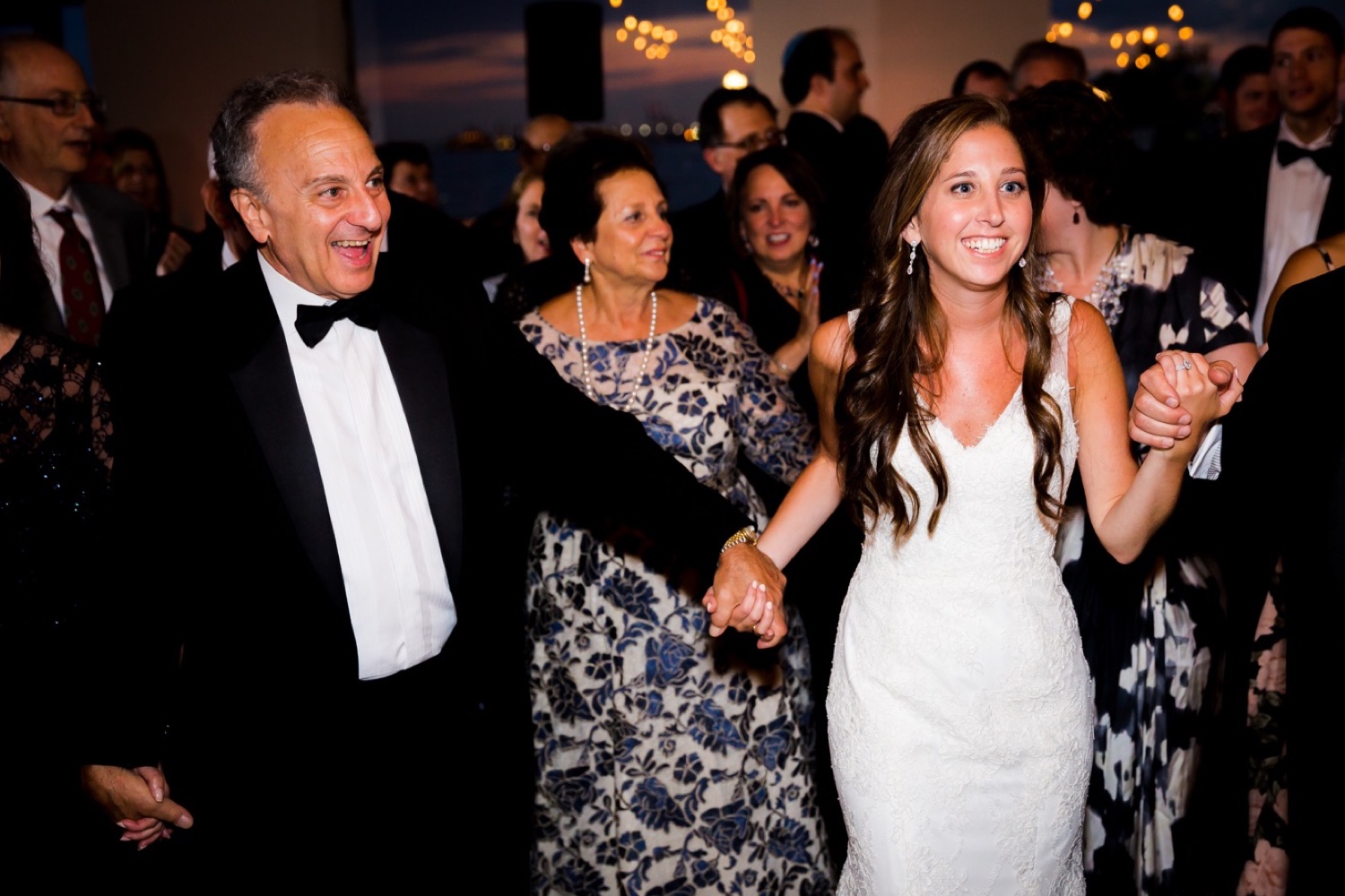 A bride dancing with her wedding guests during her wedding reception at Liberty Warehouse, Brooklyn New York.