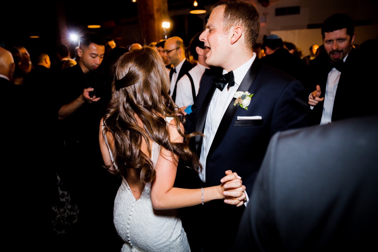 A newly wedded couple dancing together during a wedding reception at Liberty Warehouse, Brooklyn New York.