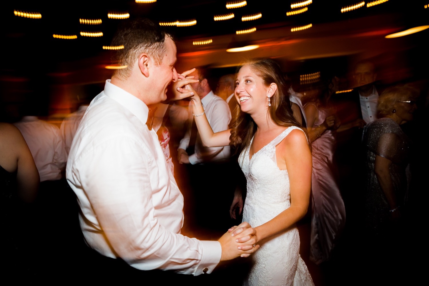 A newly wedded couple dancing together during a wedding reception at Liberty Warehouse, Brooklyn New York.