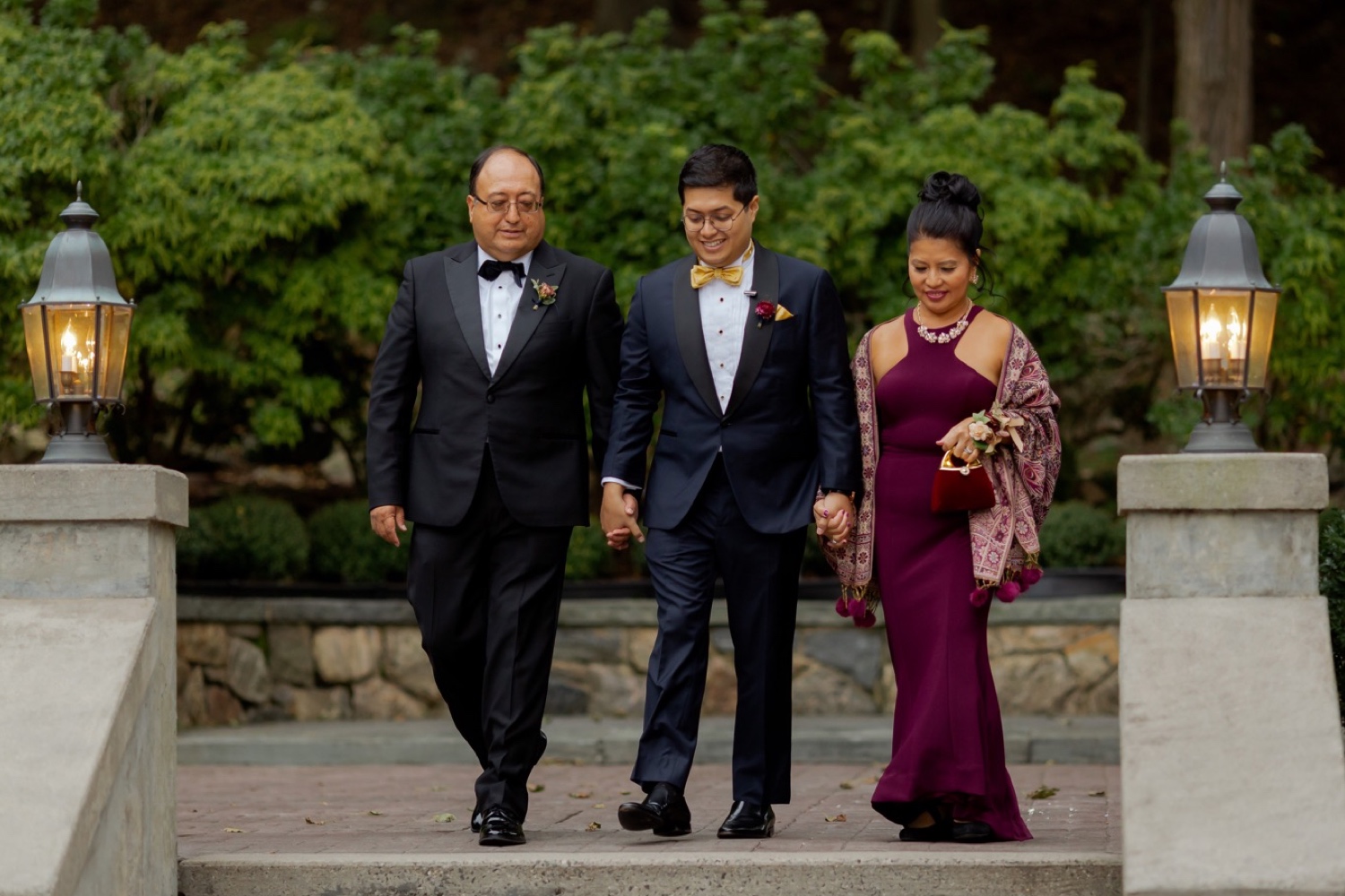 A groom and his parent walking towards the ceremony at the Tappan Hill Mansion.