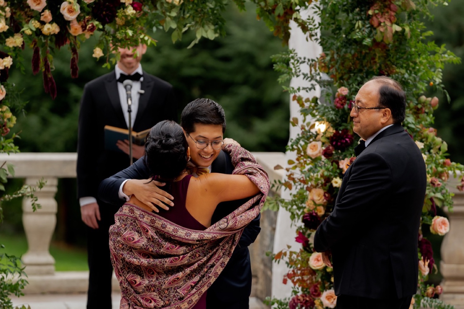 A groom hugging his mother during a wedding ceremony at the Tappan Hill Mansion.