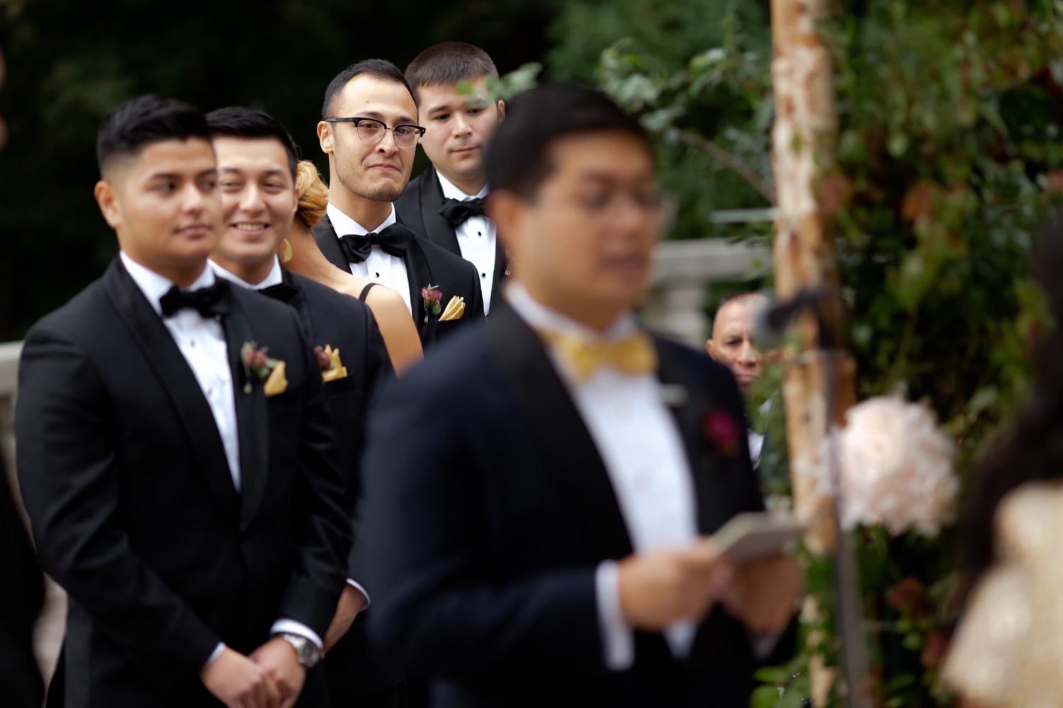 Groomsmen listening to their groom's wedding vow during a wedding ceremony at the Tappan Hill Mansion.