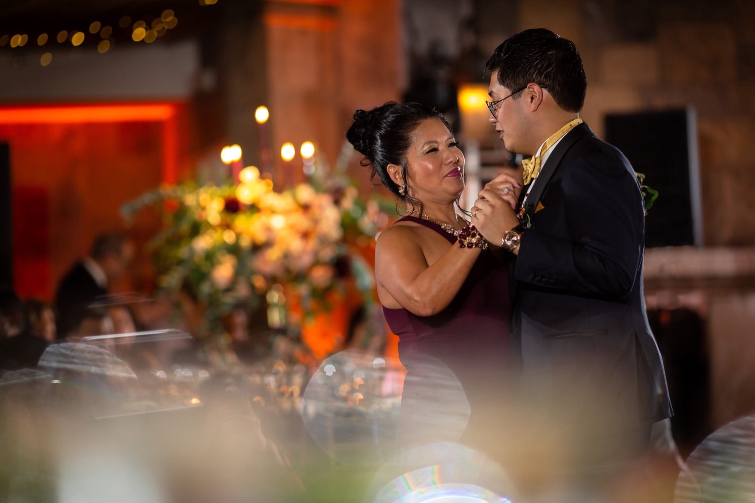 A groom dancing with his mother during a wedding reception at the Tappan Hill Mansion.