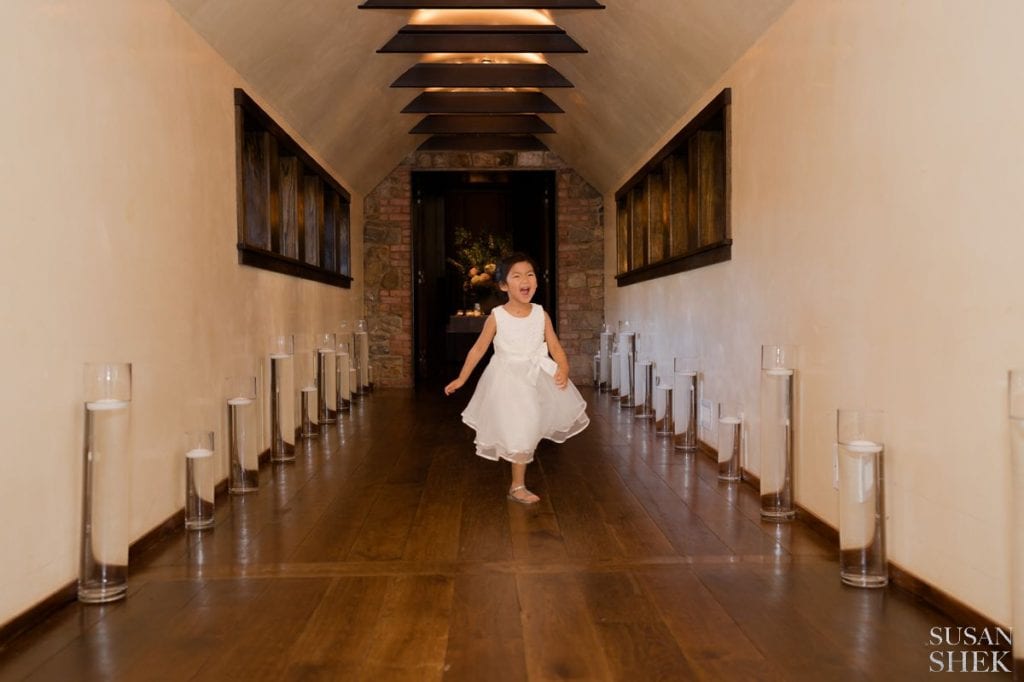 girl running through the hallway of blue hill stone barns