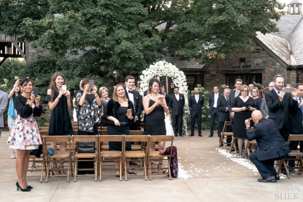 groom watching his bride come down the aisle at blue hill stone barns