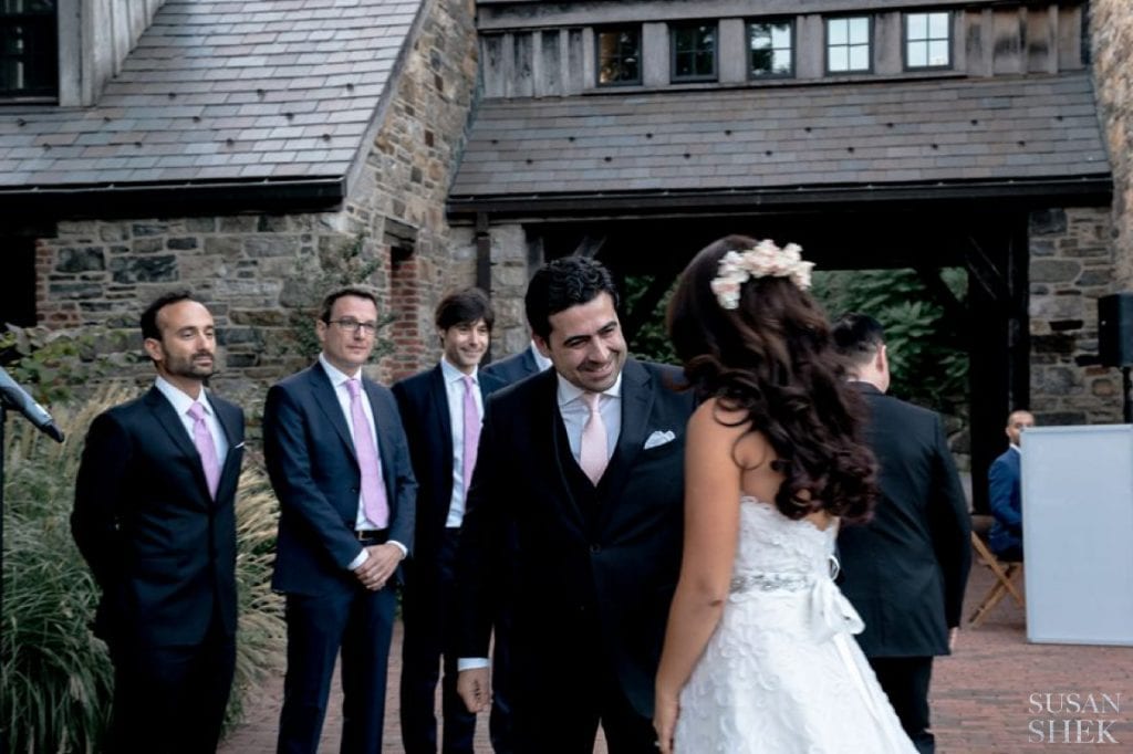 groom receives his bride at blue hill stone barns