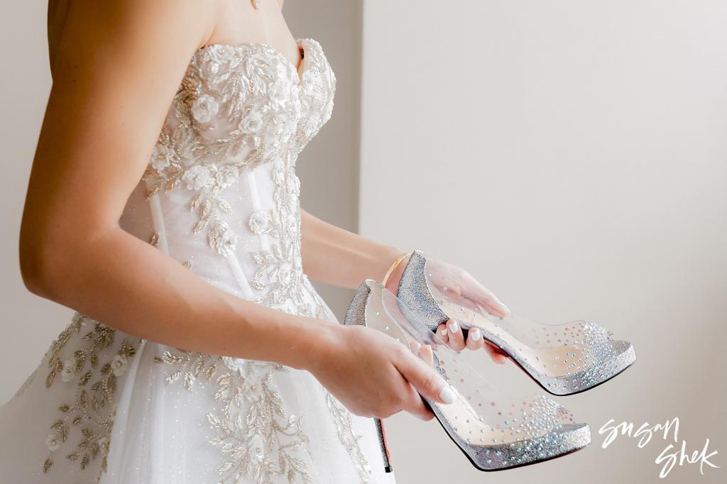 bride putting on her shoes for her wedding at the rainbow room