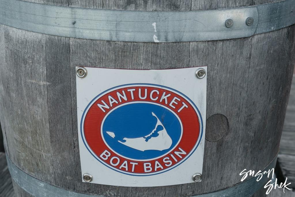 Nantucket Boat Basin sign on a weathered wooden barrel