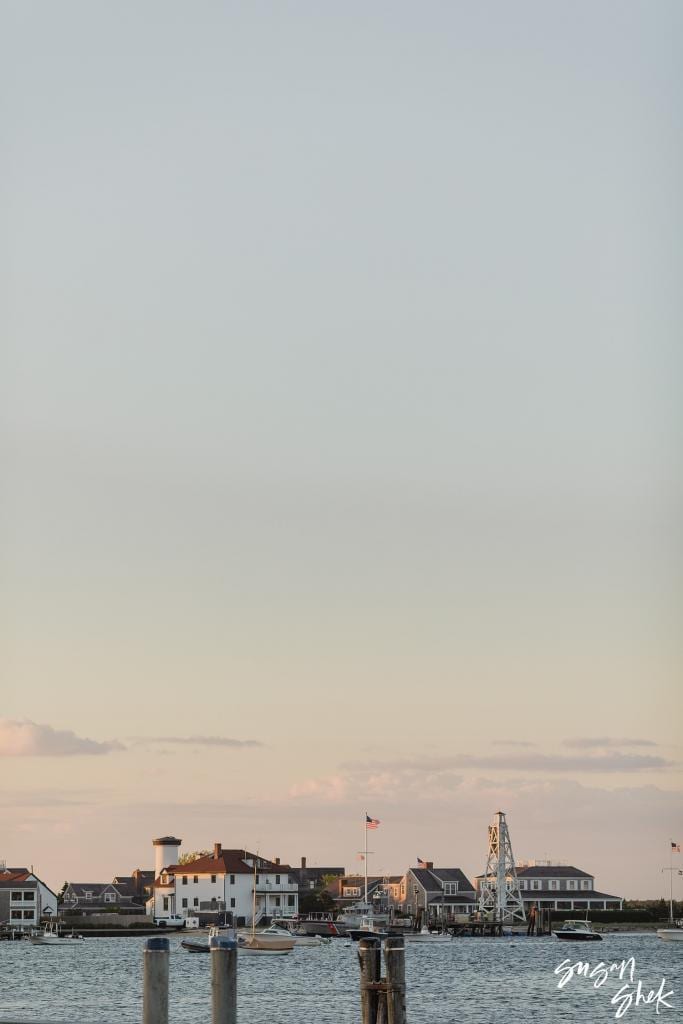 Nantucket waterfront on the horizon under a pale evening sky