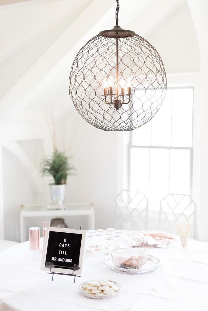 Bright cottage room with a globe pendant light and a "0 days till Mr. and Mrs." letter board