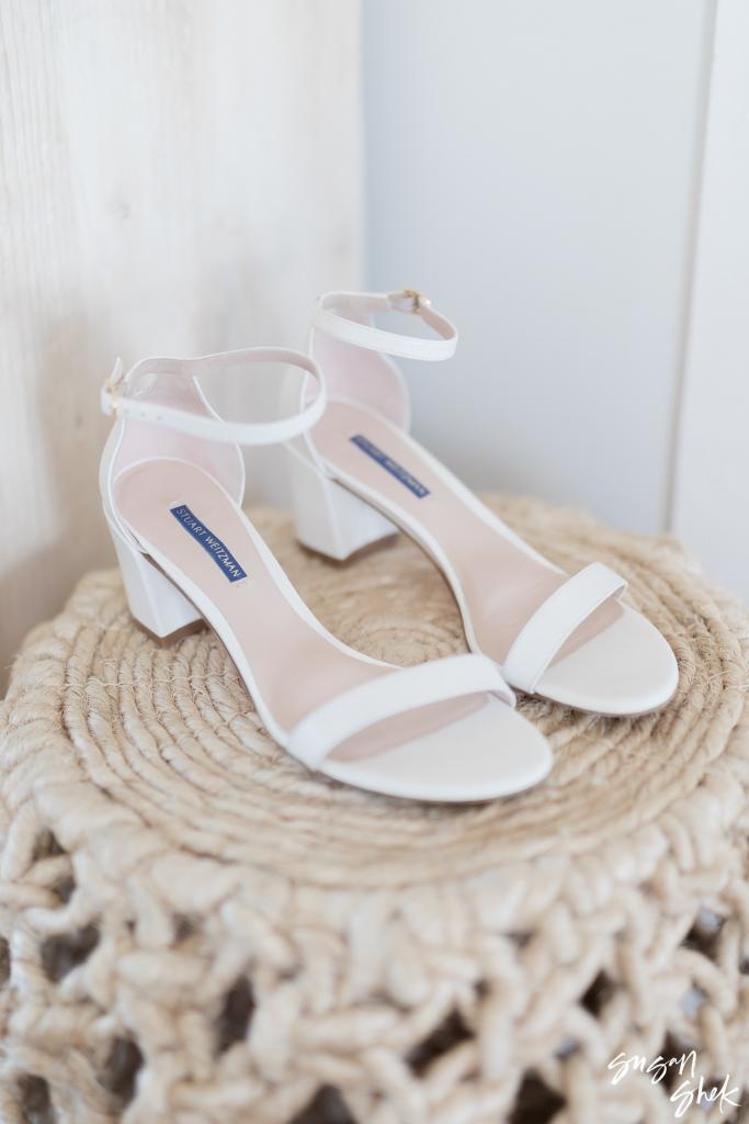 White block heel sandals on a woven rope stool