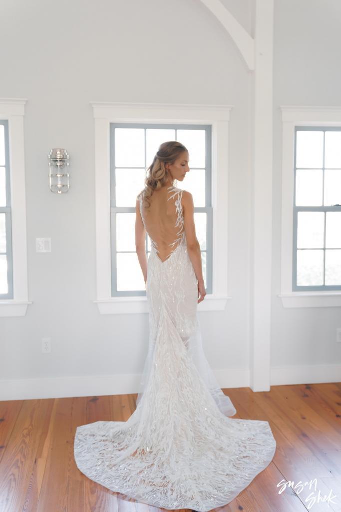 Back view of the bride's open back lace gown and long train
