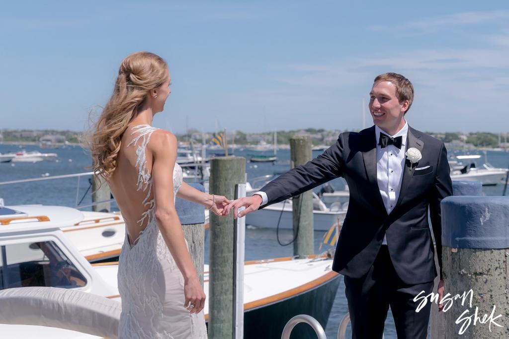 Groom turning to see the bride for the first time on the dock