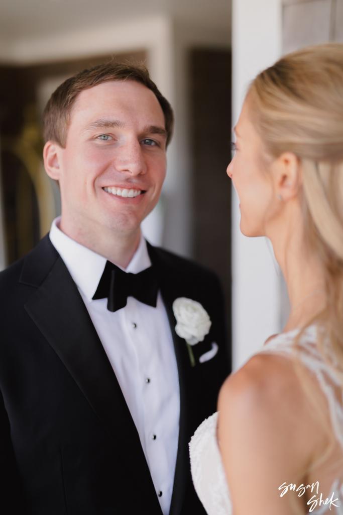 Groom smiling at the bride in a close portrait