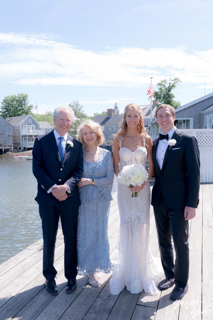Bride and groom with two family members on the dock
