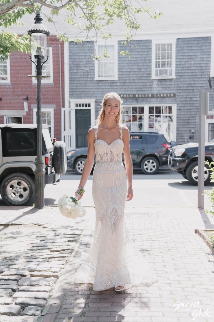 Bride walking down a cobblestone street in town