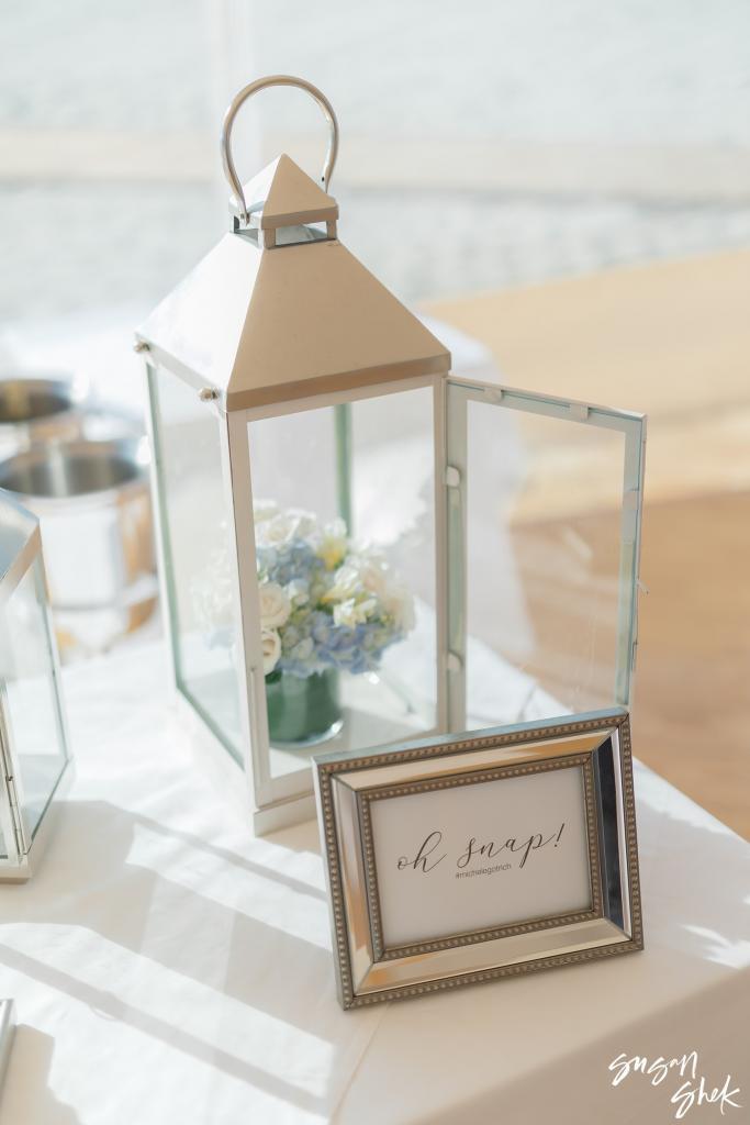 Silver lantern beside a framed "oh snap" sign