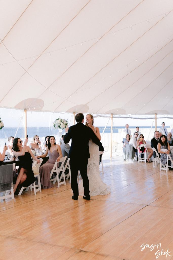 Bride and groom dancing as guests watch from their tables