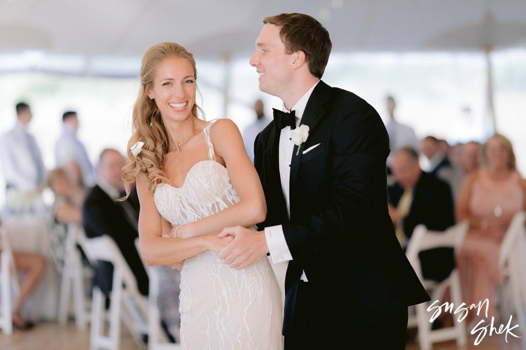 Bride and groom laughing together on the dance floor