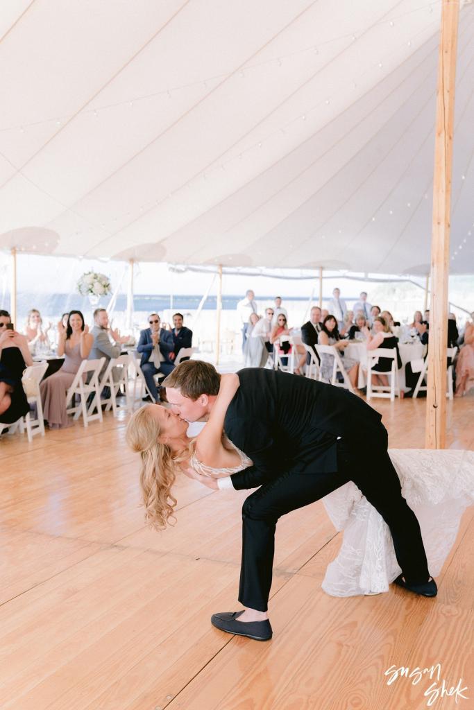 Groom dipping the bride into a kiss at the end of the first dance