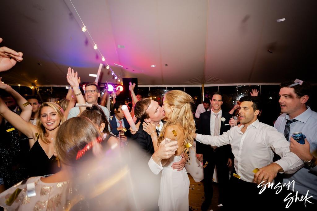 Couple kissing surrounded by guests on the dance floor at a Nantucket wedding