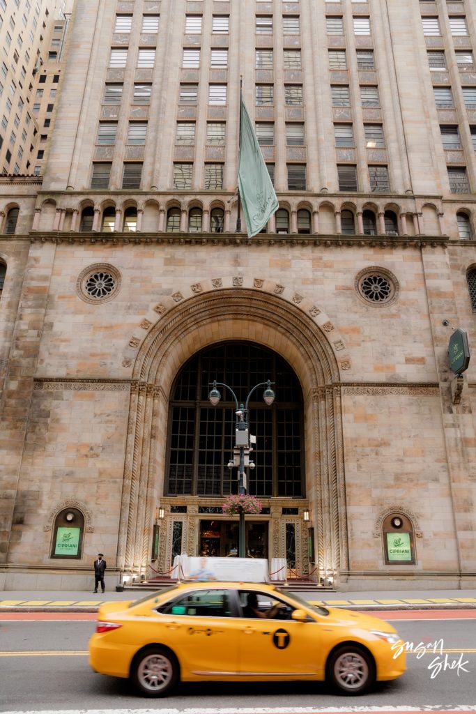 taxi passing by in front of Cipriani Wall Street