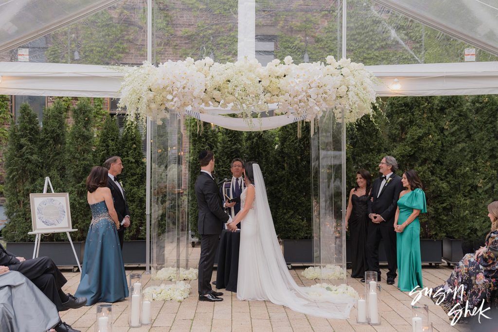 couple under the arch for their wedding at the foundry