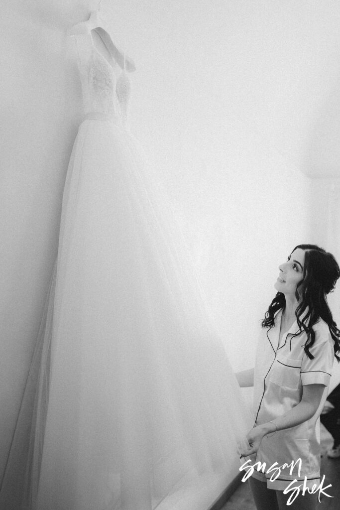Bride looking at her wedding dress at hotel in trani puglia italy