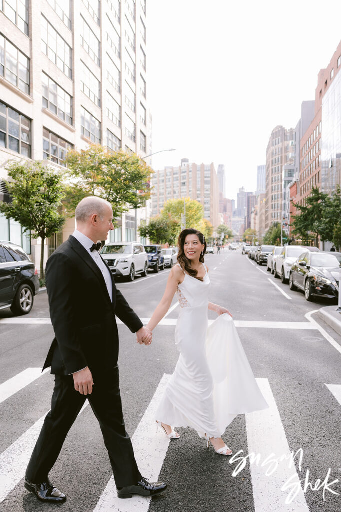 tribeca 360 couple walking across the street in downtown