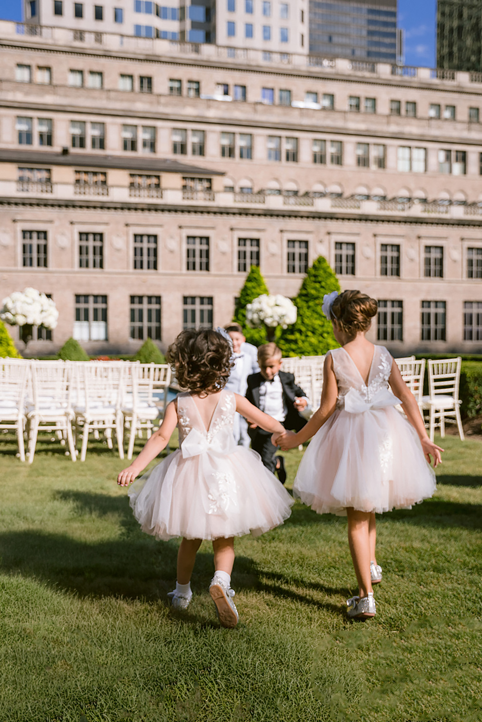 children walking across the 620 Loft and Garden rooftop lawn with cathedral backdrop