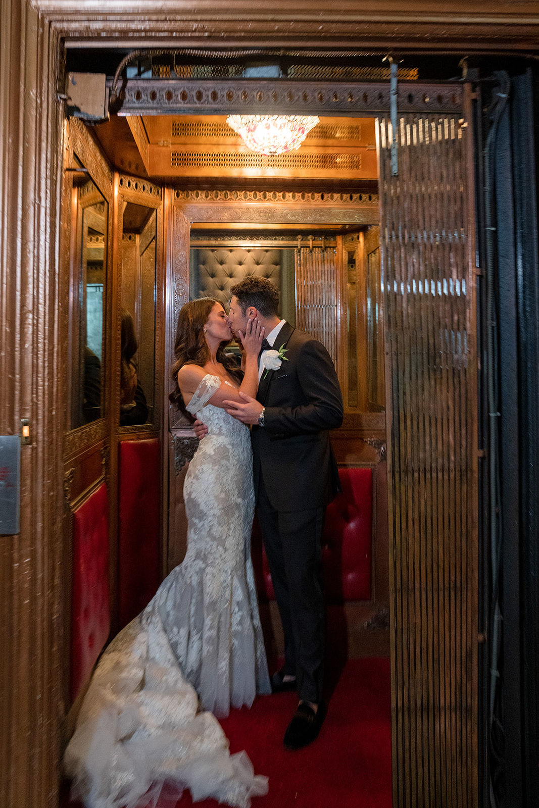 Bride and groom sharing an intimate kiss in the elevator