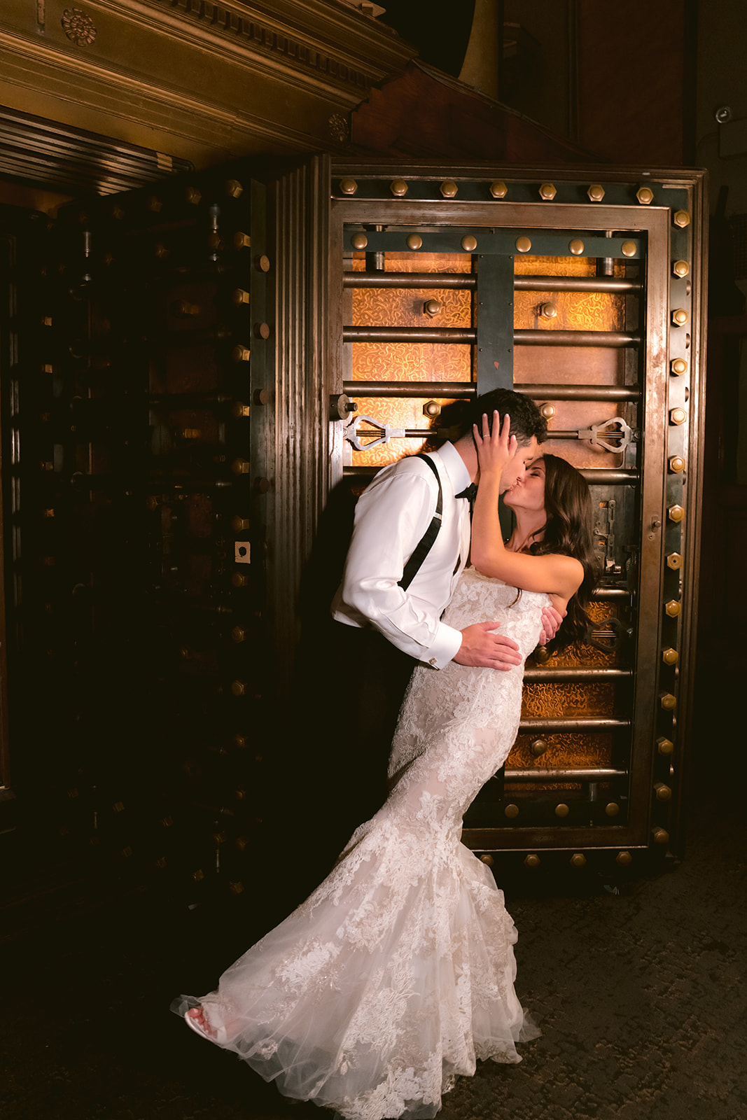 Bride and groom sharing a romantic kiss inside the old bank vault at Capitale in NYC.