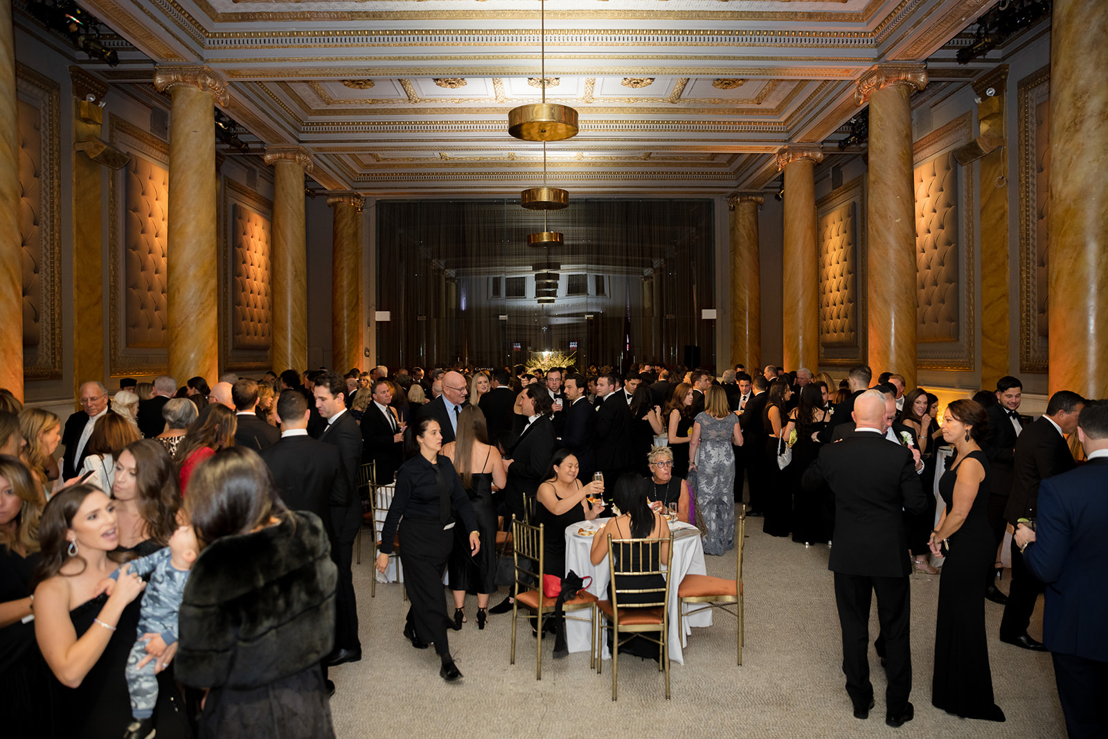 Crowded cocktail hour at a New York City wedding hosted inside the grand and gilded Capitale venue.