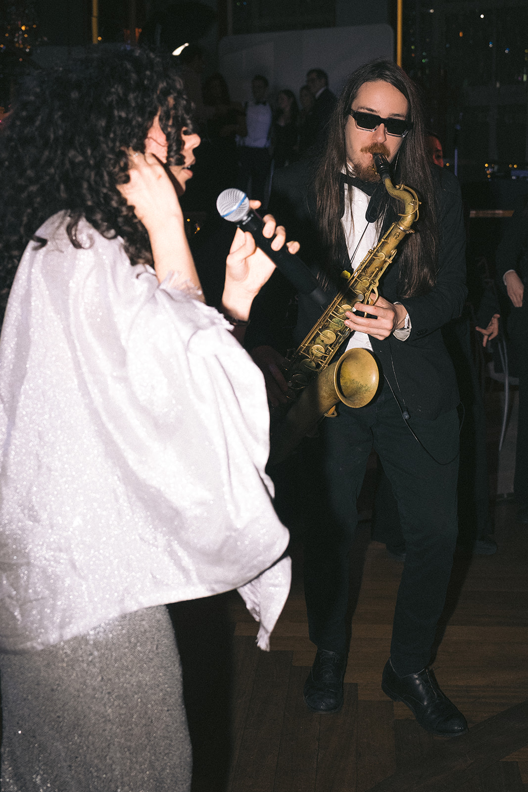 Live wedding band performance with singer and saxophonist entertaining guests at Rainbow Room in New York City.