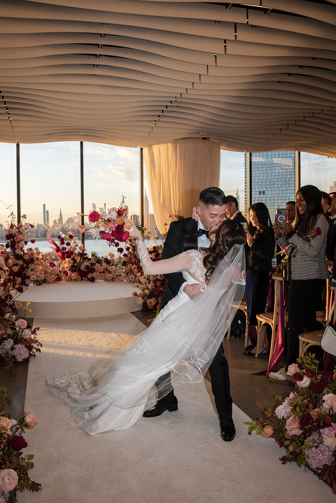 A bride and groom sharing their first kiss at the Vesper Events, a top NYC wedding venue